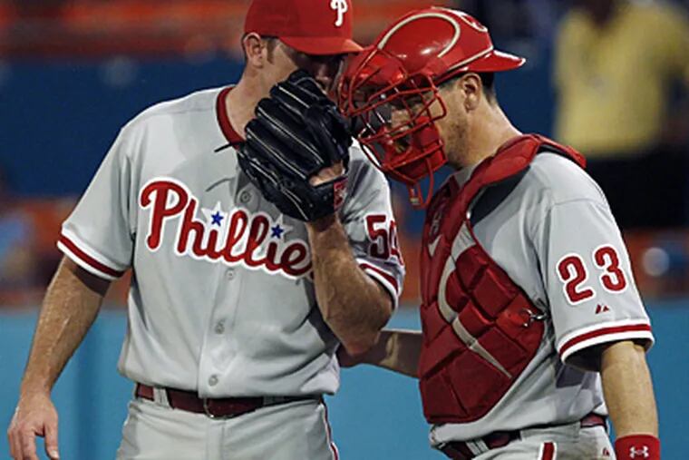 Philadelphia Phillies relief pitcher Brad Lidge, left, talks to catcher Paul Bako after Florida Marlins' Jorge Cantu hit a single driving in Ross Gload, tying the game 6-6, the ninth inning on Wednesday. Florida won 7-6. (AP Photo/Alan Diaz)