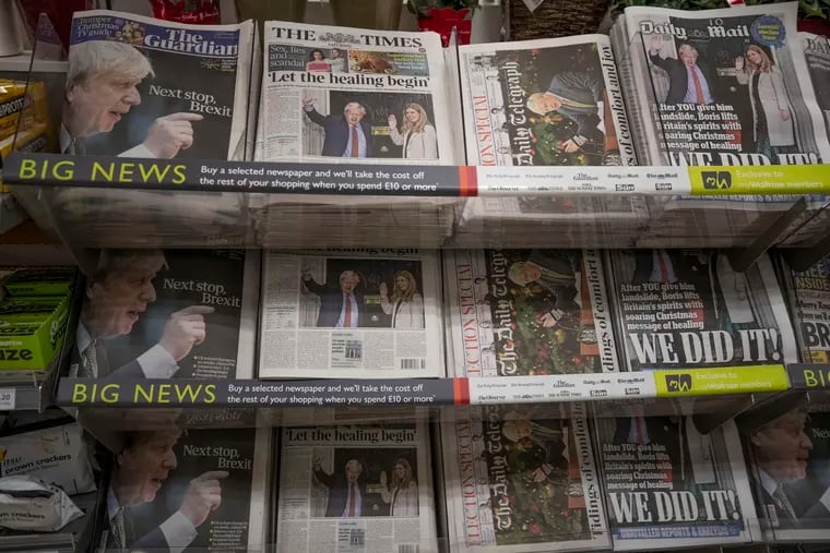 Newspapers sit on display for sale with their front pages reporting on the general election in a supermarket in south west London, Saturday, Dec. 14, 2019. Prime Minister Boris Johnson pledged Friday to heal Britain's divisions over Brexit after his gamble on early elections rewarded him with a commanding majority in Parliament and a new mandate to take his country out of the European Union at the end of January.