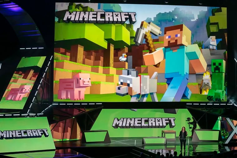 Lydia Winters shows off Microsoft's "Minecraft" built specifically for HoloLens at the Xbox E3 2015 briefing before Electronic Entertainment Expo, June 15, 2015, in Los Angeles. Security experts around the world are racing to patch one of the worst computer vulnerabilities discovered in years, a critical flaw in open-source code widely used across industry and government in cloud services and enterprise software. Cybersecurity experts say users of the online game Minecraft have already exploited it to breach other users by pasting a short message into in a chat box. (AP Photo/Damian Dovarganes, File)