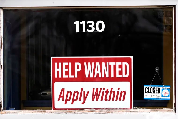 A "help wanted" sign is seen at an Allstate insurance office in Elgin, Ill., March 19, 2022.