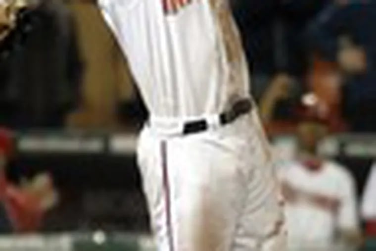 Washington&#0039;s Chris Snelling celebrates after scoring the winning run on a sacrifice fly by Felipe Lopez. For a change, the Phillies&#0039; bullpen acquitted itself well.