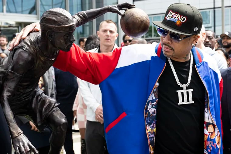 Allen Iverson takes a close look at his statue at Friday's unveiling in Camden.