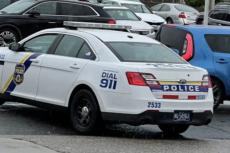 A store employee took this picture of the departing police car after an officer allegedly shoplifted at the store on Friday.