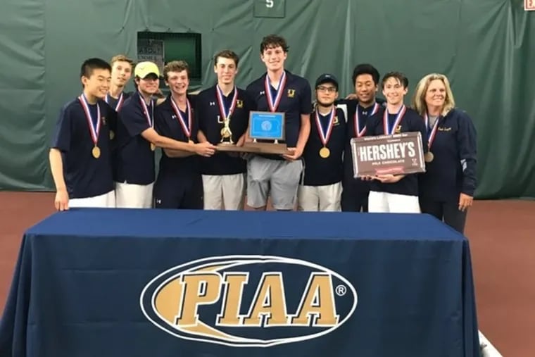 The Unionville boys’ tennis team poses with its hardware after winning the PIAA Class 3A championship.