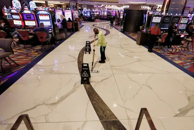 Leo Canayunan cleans the main walkway on the casino floor just after 10 p.m. at the Hard Rock Hotel & Casino Atlantic City. Because of a resurgence of coronavirus cases, food and beverage service ends at 10 pm.