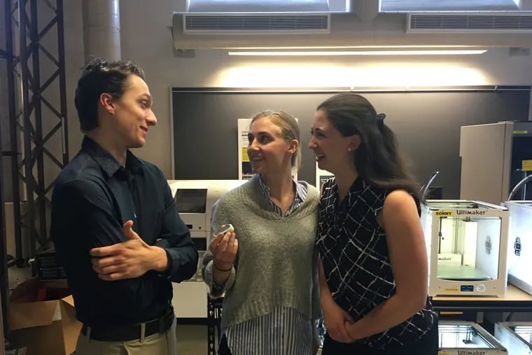 Lehigh University engineering students Chris Szafranski (left), Lena McDonnell (center) and Brooke Glassman talk about the device they created to improve safety for women, Soterra, which McDonnell is holding.