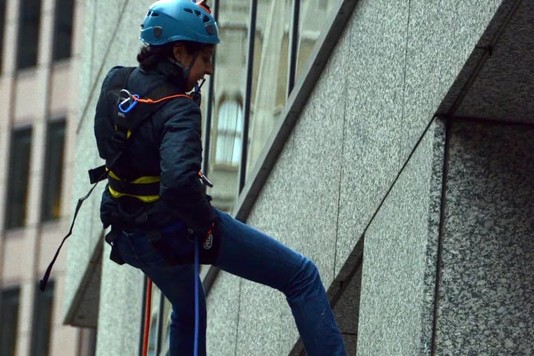Helen Ubinas, finishing her windy rappel down 31 stories at One Logan Square during a two-day fundraiser for the program. Courtesy of Philadelphia Outward Bound School.