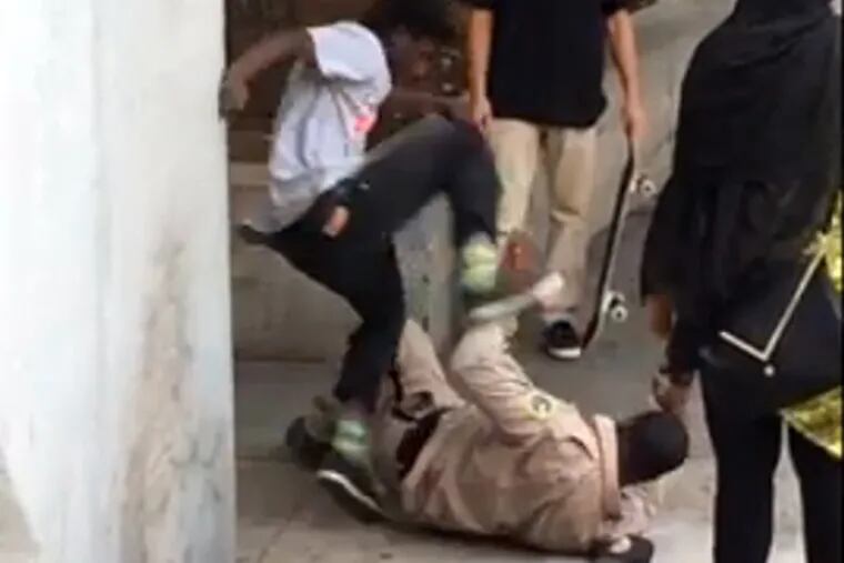A video, posted online by a witness Friday and turned over to police on Saturday, shows a young man hitting and kicking a park ranger as others stood by laughing.