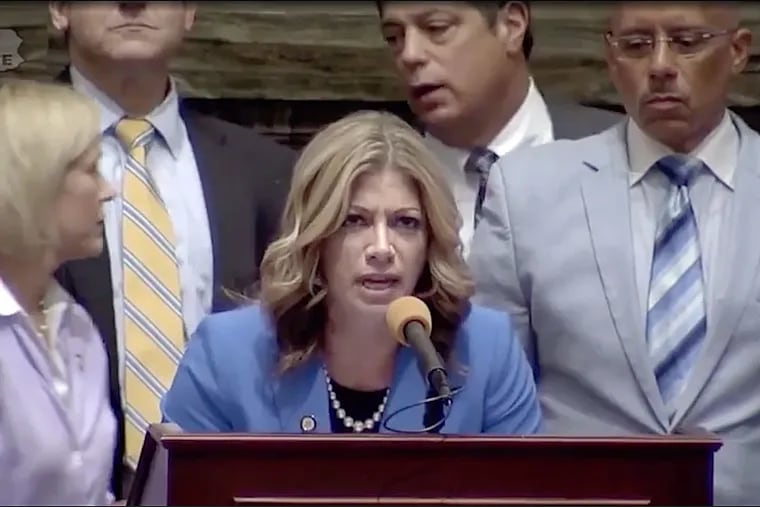 Democratic Sen. Katie Muth of Montgomery County reads a letter from a man who used to be homeless while Republican Senate Majority Leader Jake Corman yells in an attempt to get her to stop.