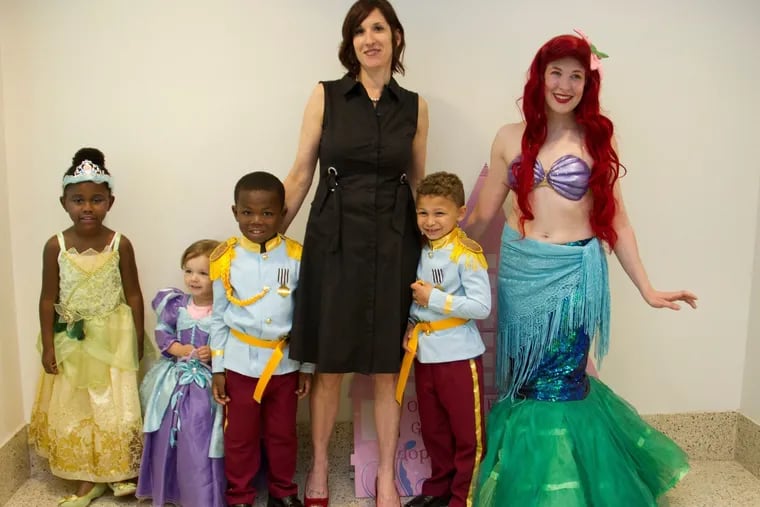Stacie Farrell, with children (from left) Lillyanna, Gabby, Quadree and Michael, along with the mermaid who made a special appearance at Gabbys adoption hearing in May.