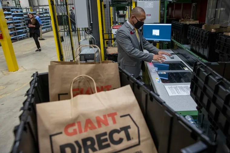 Angel Cordero the E-commerce Facility Manager, demonstrating the "selection station auto store." The GIANT Company opened a grocery fulfillment center in the Eastwick section of Philadelphia. The ribbon cutting occurred on Monday morning November 8, 2021.