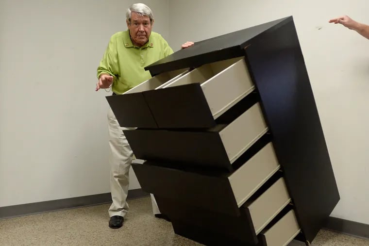 Bobby Puett, president of Diversified Testing Labs, watches as the Ikea Malm six-drawer dresser falls over during a tip over test at Diversified Testing Labs in Burlington, North Carolina, September 17, 2015.