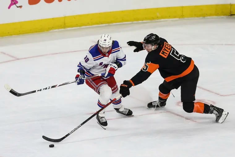 Flyers defenseman Phil Myers knocks the puck away from the Rangers' Artemi Panarin during a Feb. 28 game.