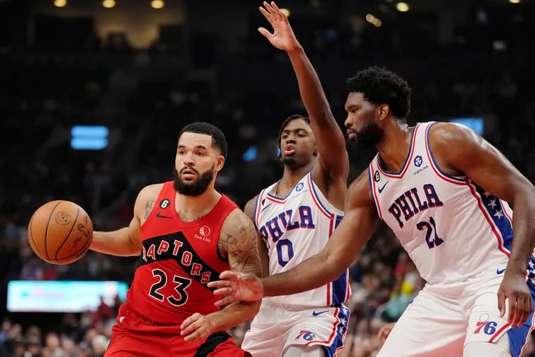 Toronto Raptors guard Fred VanVleet (23) protects the ball from Philadelphia 76ers guard Tyrese Maxey (0) and center Joel Embiid (21) during the first half of an NBA basketball game, Wednesday, Oct. 26, 2022 in Toronto. (Frank Gunn/The Canadian Press via AP)
