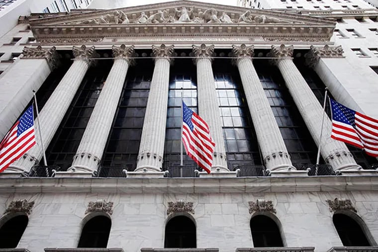 In this Feb. 10, 2011 file photo, American flags fly in front of the New York Stock Exchange, in New York. Asian stock markets fell for a second day Thursday June 12, 2014 and European shares drifted as a dimmer outlook for global growth this year gave investors a reason to lock in recent gains.  (AP Photo/Mark Lennihan, File)