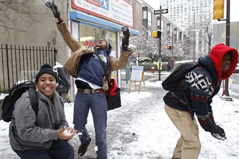 Greenfield Elementary School students Aarin Dreher, left, Yasr King,
center, and Robert Gary, right, take turns throwing snowballs at classmates after an early dismissal on Wednesday. (David Maialetti / Staff Photographer)