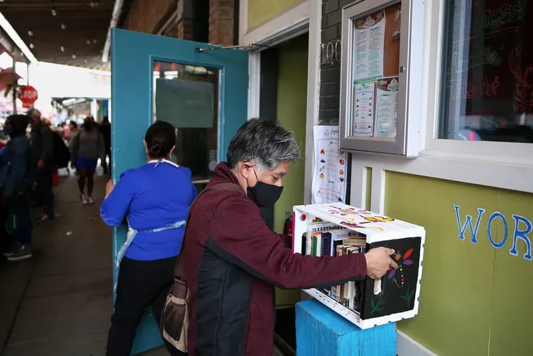 Edgar Ramírez of Philatinos Radio installs a Philibros bookshelf on a stand outside Alma del Mar in South Philadelphia on April 10, 2021. Ramírez is one of the organizers of the Philibros World Book Day celebration at the Mexican Cultural Center in Philadelphia on April 23, 2024.