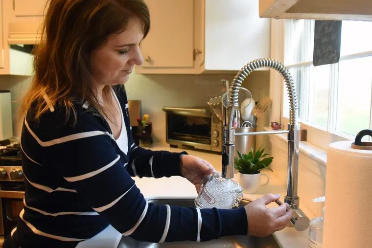 Kati Angelini, a member of the Moorestown Water Group, is using tap water in her house because, she said, a sophisticated water filter has been installed.