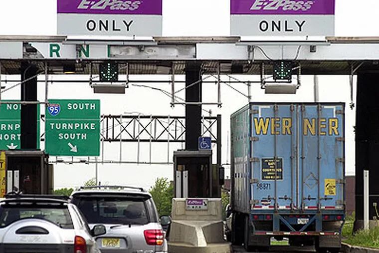 Cars and a truck go through the E-ZPass lanes at Exit 8A of the New Jersey Turnpike in Monroe Township, N.J. in this May 12, 2003, file photograph. (AP Photo / Daniel Hulshizer)