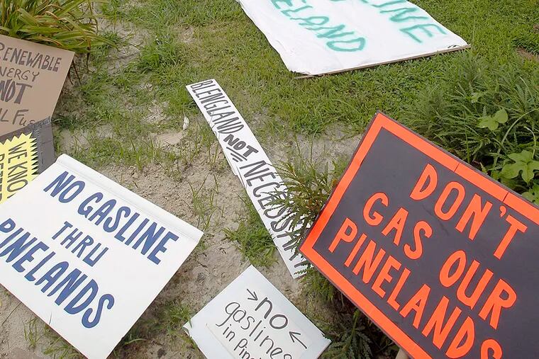 Protest signs lay at the N.J. Pinelands Commission office ground on July 26, 2013. ( AKIRA SUWA  / Staff Photographer )