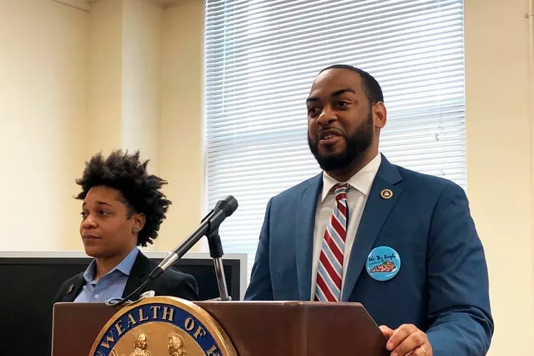 Kentucky state Rep. Charles Booker, right, promotes a voting-rights measure on Wednesday, Jan. 29, 2020, in Frankfort, Ky. Booker is the lead sponsor of a proposed constitutional amendment that would automatically restore voting rights for felons who have completed their sentences.