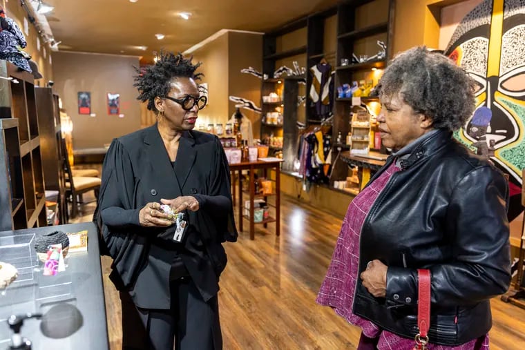 Dorothea Gamble, of Northern Liberties, Pa., owner of Trunc, talks with June Terrell, of Mount Airy, at Gamble's Northern Liberties store on Wednesday.