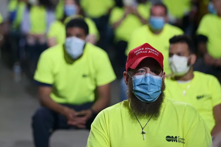 Workers wait to listen to President Donald Trump speak during a visit to the Owens & Minor medical equipment distribution center in Allentown, Pa., on Thursday, May 14, 2020. The president has called for Pennsylvania to speed the process of reopening businesses after the coronavirus shutdown.