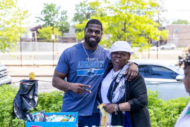 Casey Williams, 26, of North Philadelphia, is heading north of the border to play for the Toronto Argonauts. His mother, Zina (right), will be cheering him on.