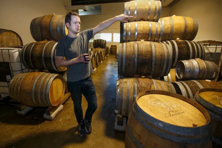 The Referend Bier Blendery owner James Priest stands in the barrel aging room among different varieties of beer that are aging in oak barrels and talks about their blendery process.