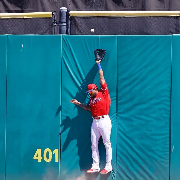 Phillies center fielder Edmundo Sosa attempts to catch the Braves Marcell Ozuna’s two RBI double.