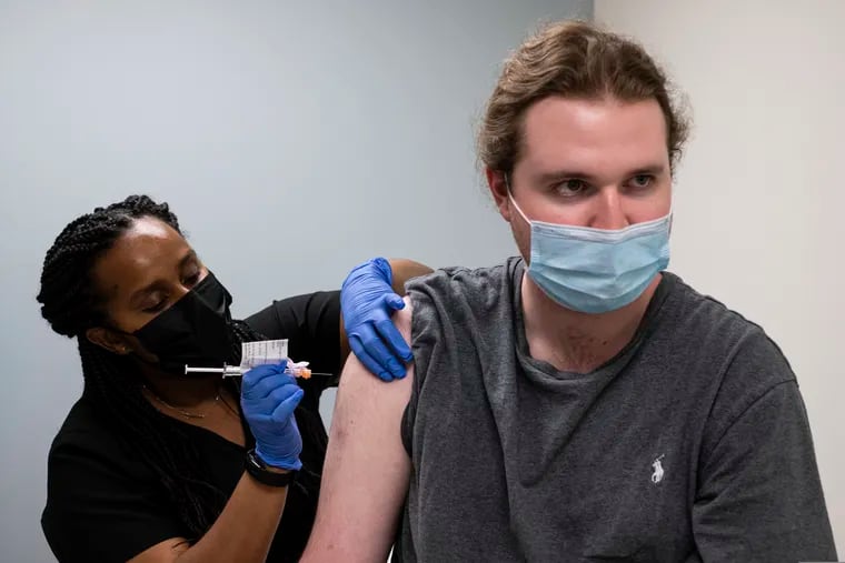 Cole Smith received a Moderna variant vaccine shot from clinical research nurse Tigisty Girmay at Emory University's Hope Clinic in late March.