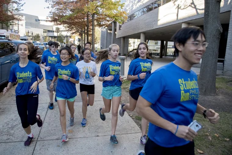 Steve Lin (right), an adult volunteer for the Masterman Students Run Philly Style club, leads some of the students down N. 17th St. (heading south) on November 7, 2016.  In its 10th year, Students Run Philly Style has clubs at schools throughout the city and they compete in both the Philly 10k run and the Philly marathon.