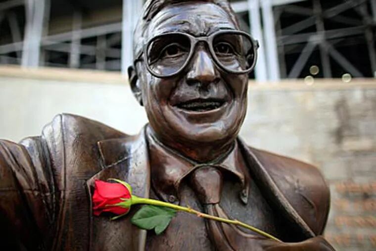 A rose rests on the Joe Paterno statue outside of Beaver Stadium. (David Swanson/Staff Photographer)