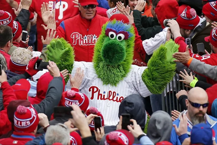 The Phillie Phanatic leads players through the crowd at Ashburn Alley before the Phillies play their home opener against the Washington Nationals on Friday, April 7, 2017 in Philadelphia. YONG KIM / Staff Photographer.