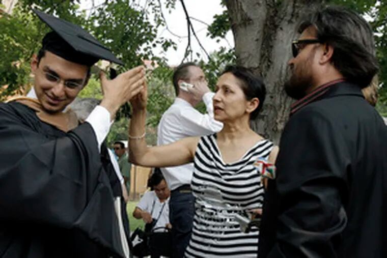 Mother still knows best: Sumit Pathak of Dubai, United Arab Emirates, takes direction from his mother, Pormime, after graduating from Drexel. Standing by is his father, Sunil.