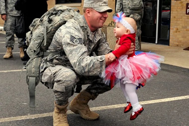 Staff Sgt. Jeffery Stich Jr. of Levittown with daughter Kyleigh, 11 months. Stich said of his service, "To be able to go over there and know I could do something to help another country" was worth the effort. (Tom Gralish / Staff Photographer)