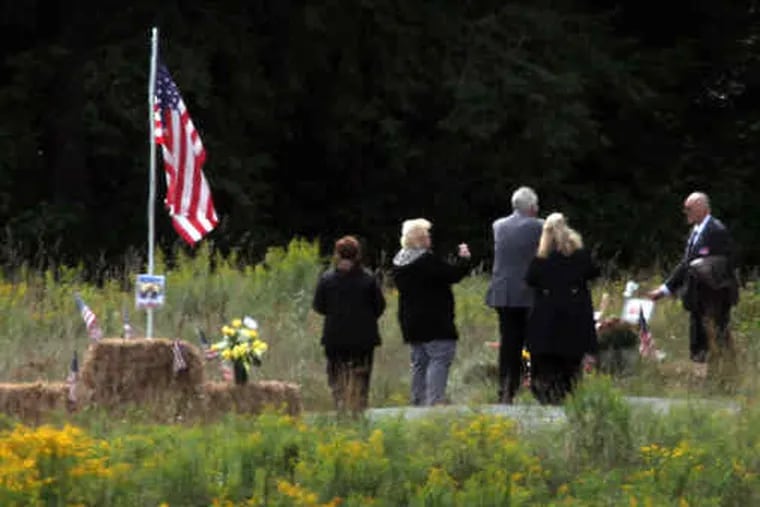 Family of those killed on United Flight 93 gather at the point of impact, which had been closed off until Saturday.