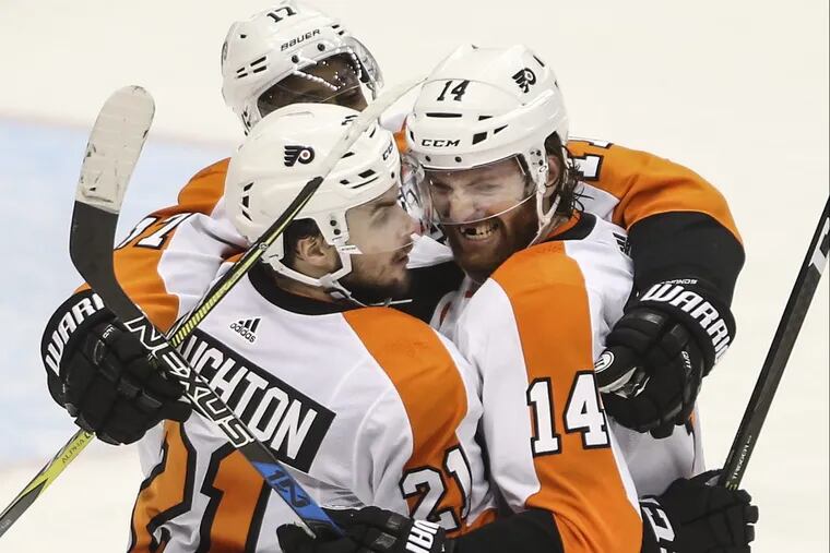 Flyers’ forward Sean Couturier celebrates his go-ahead goal against the Penguins on Friday.