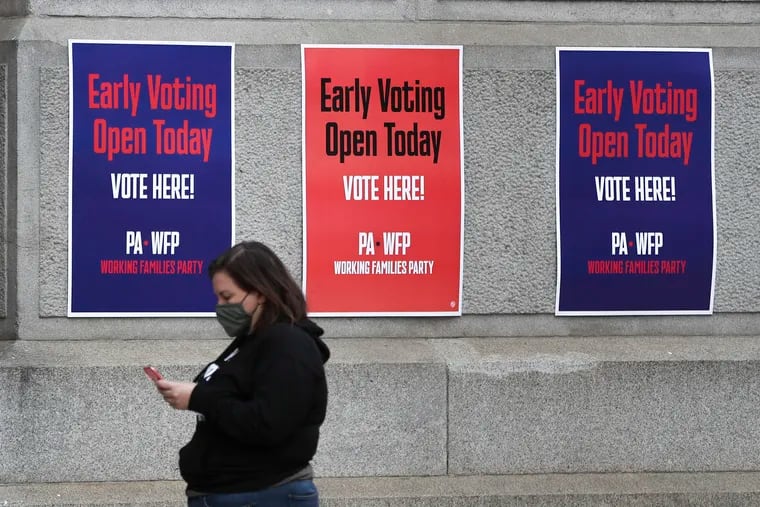 Signs encoring people to vote early from the Working Families party hang outside of City Hall where people have been submitting ballots for early voting in Philadelphia on Friday, Oct. 09, 2020.
