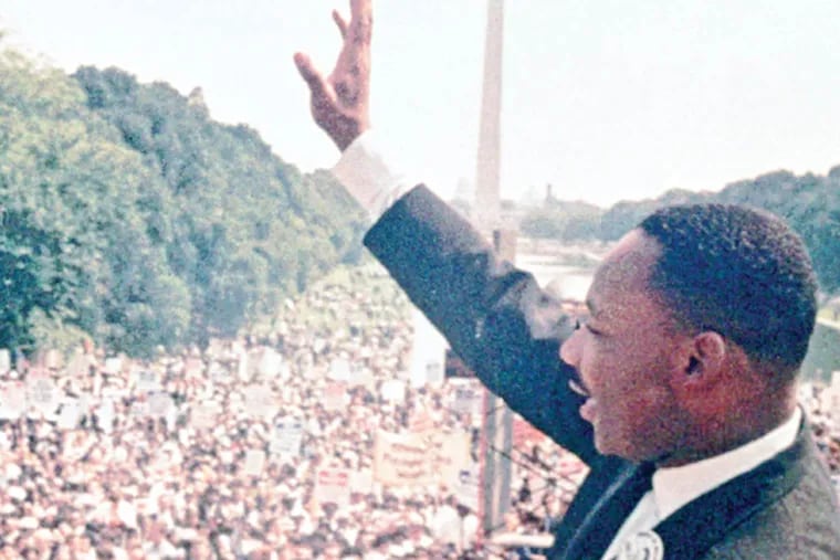 Dr. Martin Luther King Jr. acknowledges the crowd at the Lincoln Memorial for his "I Have a Dream" speech during the March on Washington, D.C., in Aug. 28, 1963.