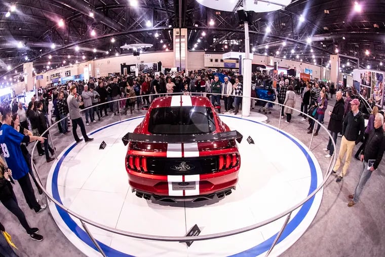 Visitors gather to get a close look -- but not touch -- the new Ford GT 500 displayed at the 2019 Philadelphia Auto Show at the Convention Center Sunday.