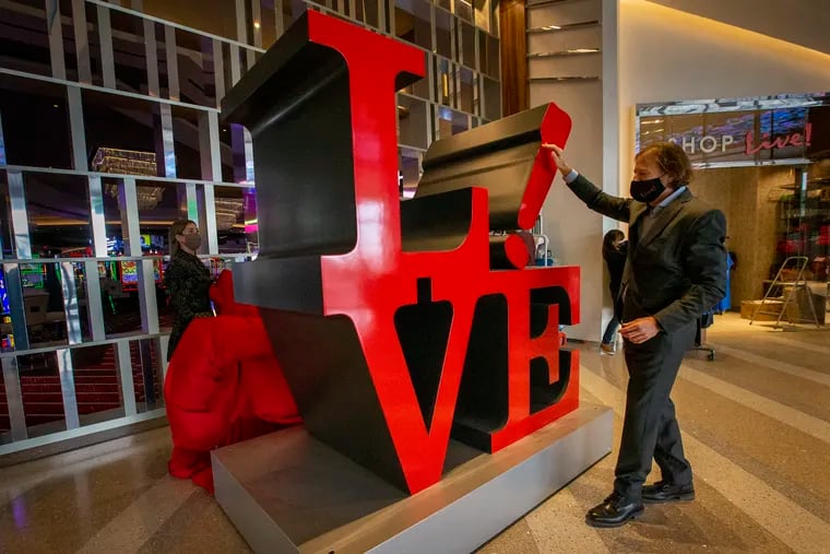 Joseph Weinberg, chief executive officer of Cordish Gaming, unveils a sculpture in the lobby of the Live! Casino and Hotel Philadelphia that is a play on the famous Robert Indiana "LOVE" statue in Philadelphia. The casino is scheduled to undergo testing on Saturday and Sunday and will open to the public, by reservation only, on Tuesday.