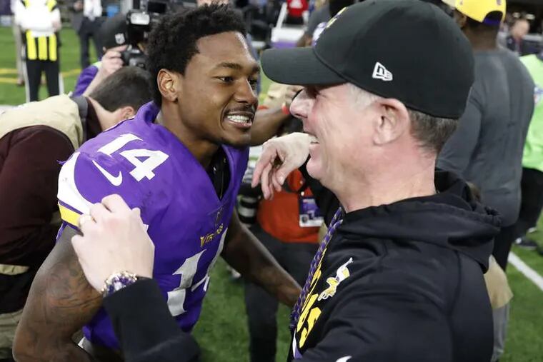 Minnesota Vikings wide receiver Stefon Diggs (14) celebrates with offensive coordinator Pat Shurmur following a 29-24 win over the New Orleans Saints in an NFL divisional football playoff game in Minneapolis on Sunday.