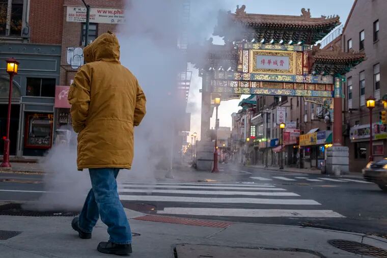 Sub-freezing temperatures send steam into the air at corner of North 10th and Arch streets in Philadelphia's Chinatown section on  Friday morning.