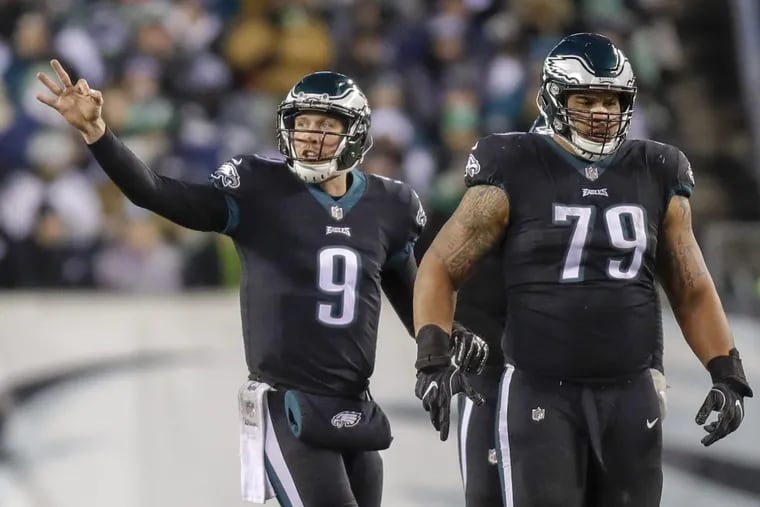 Eagles quarterback Nick Foles signals with offensive guard Brandon Brooks against the Oakland Raiders on Monday, December 25, 2017 in Philadelphia. YONG KIM / Staff Photographer