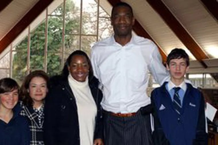 At the Episcopal Academy presentation of money for a hospital in the Congo are (from left) student Meredith Nelson, her mother, Gail Nelson, Rose Mutombo and Dikembe Mutombo of the Mutombo Foundation, and student Alex Nelson, Meredith&#0039;s brother.