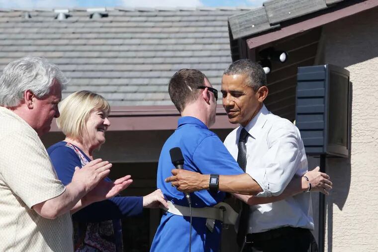 President Obama greets Sgt. 1st Class Cory Remsburg, with his father and stepmother, at the wounded Army Ranger's new home.