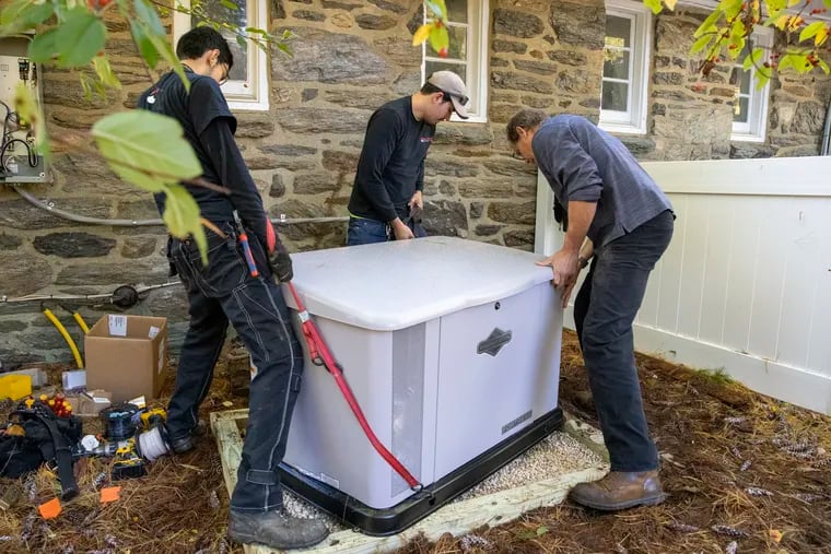 A crew from All Phase Electric Co. in Upper Darby installs a 20 kilowatt Briggs & Stratton  standby generator at a home in Upper Providence, seven months after it was ordered by the homeowner. Demand for generators has soared as more people work from home. The crew, from left, are Ryan Ballinger, Bryan Callaghan and John Phillips.