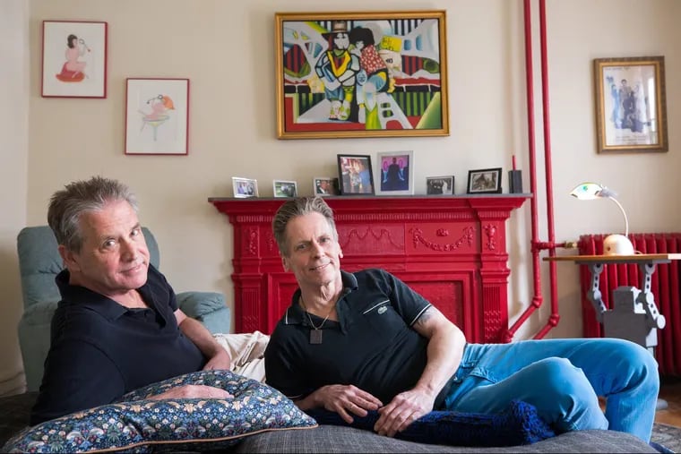 Joe McCole (left) and Dan Hart have decorated their apartment with works from their favorite artists, including the painting above the mantel by Jane Krupp. 