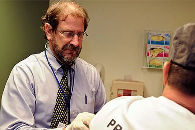 Jay Kostman, associate director of the Center for Viral Hepatitis at the University of Pennsylvania Health System, administers peginterferon to one of his patients. (Ron Tarver / Staff Photographer)